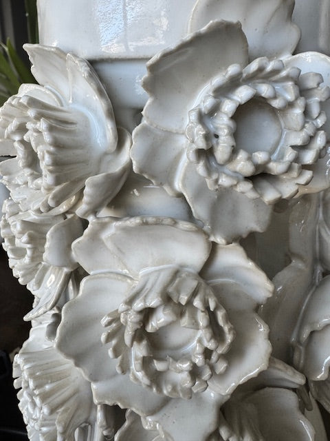 Close-up of a detailed floral sculpture in white stone