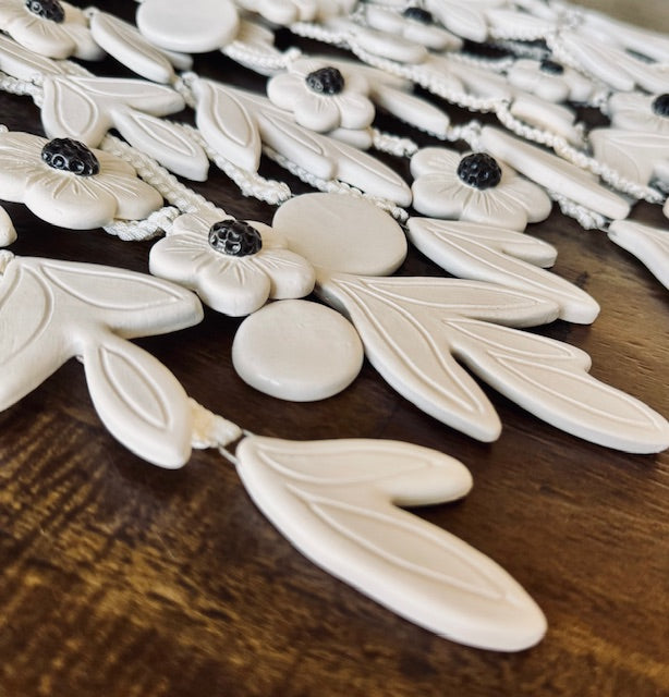 White floral ceramic tiles on a wooden surface